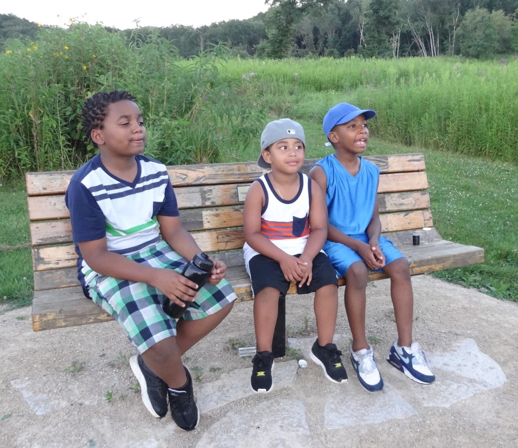 Kids firefly hike on bench at Indian Lake County Park